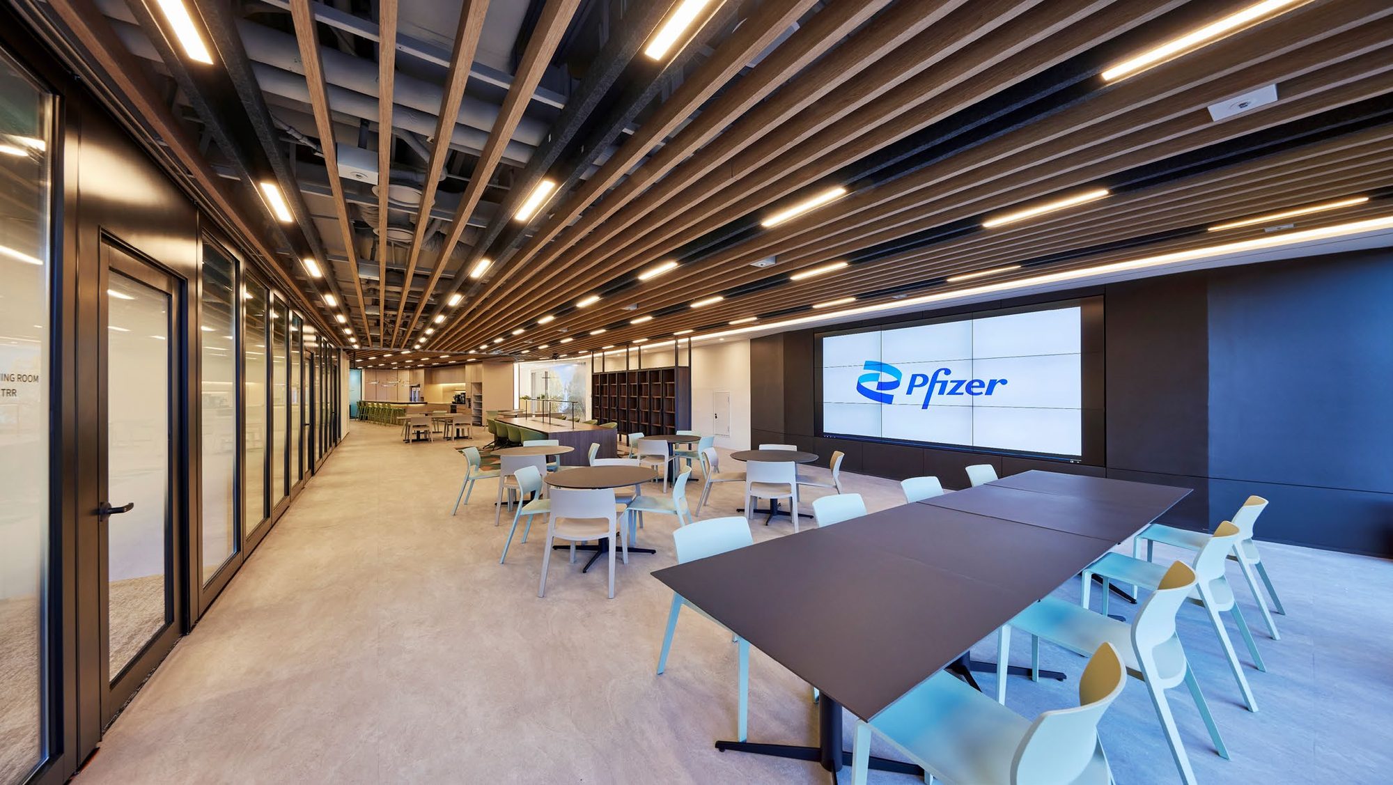Corridor with wood slat ceiling leading to meeting rooms