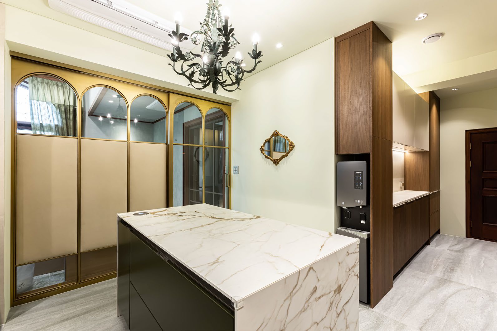 Kitchen with marble island and chandelier