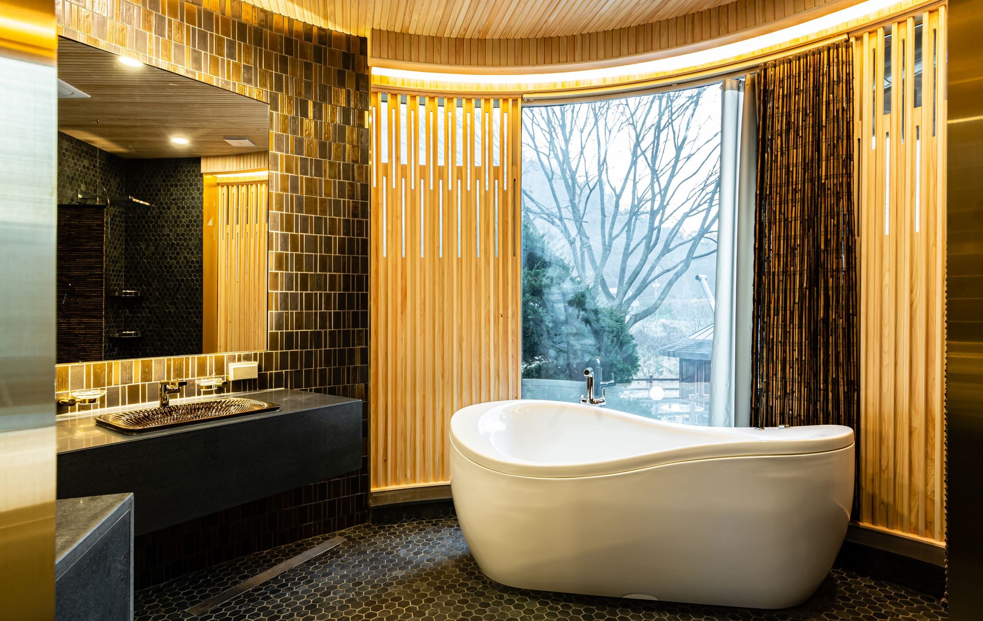 Bathroom with freestanding tub and wood slats