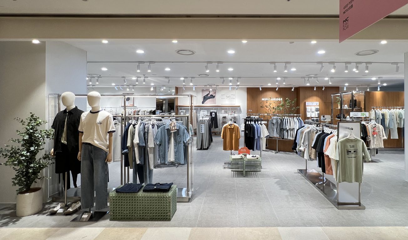 Store interior with clothing racks near entrance