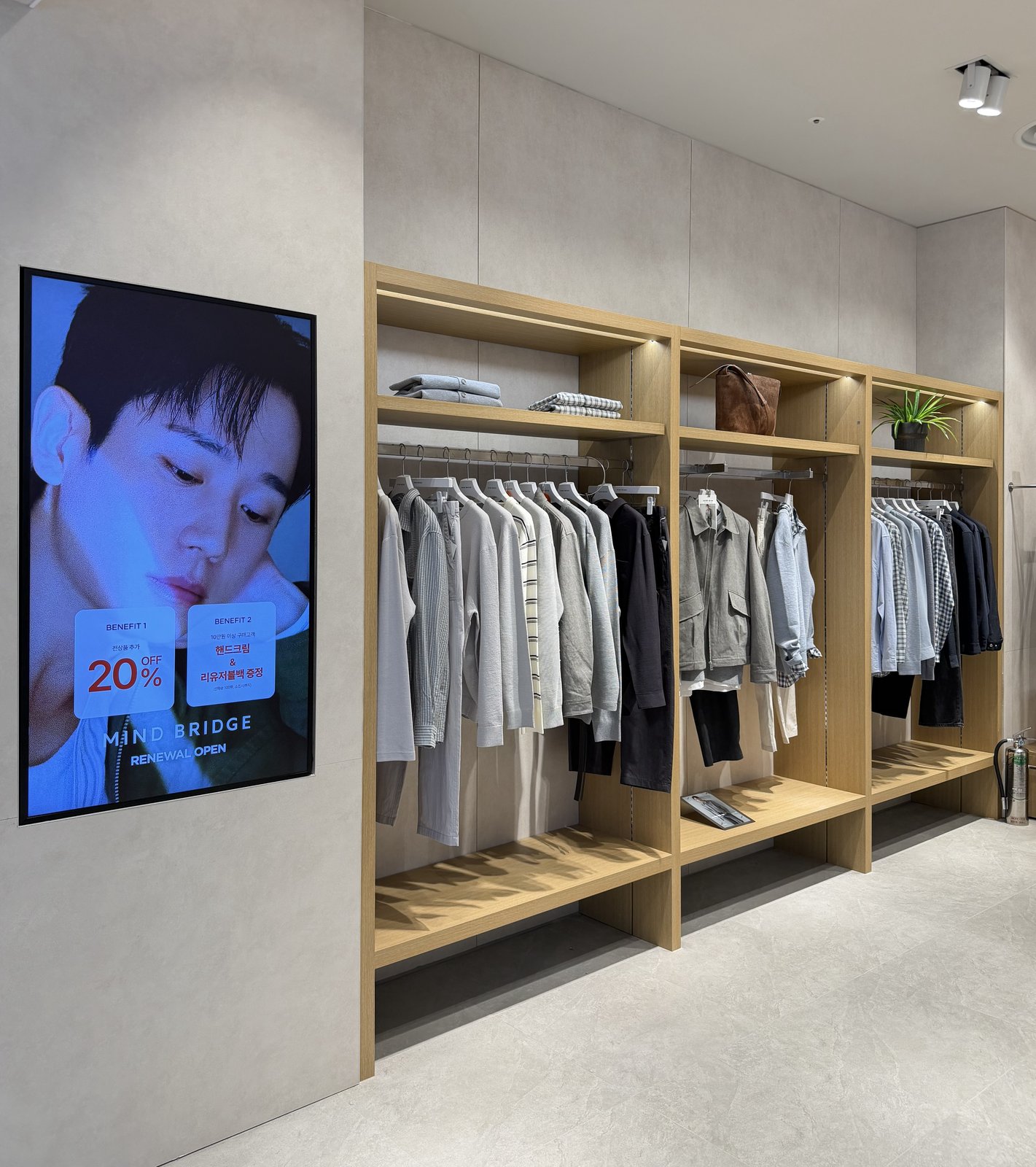 Renewal Open promotional wall display beside wood shelving