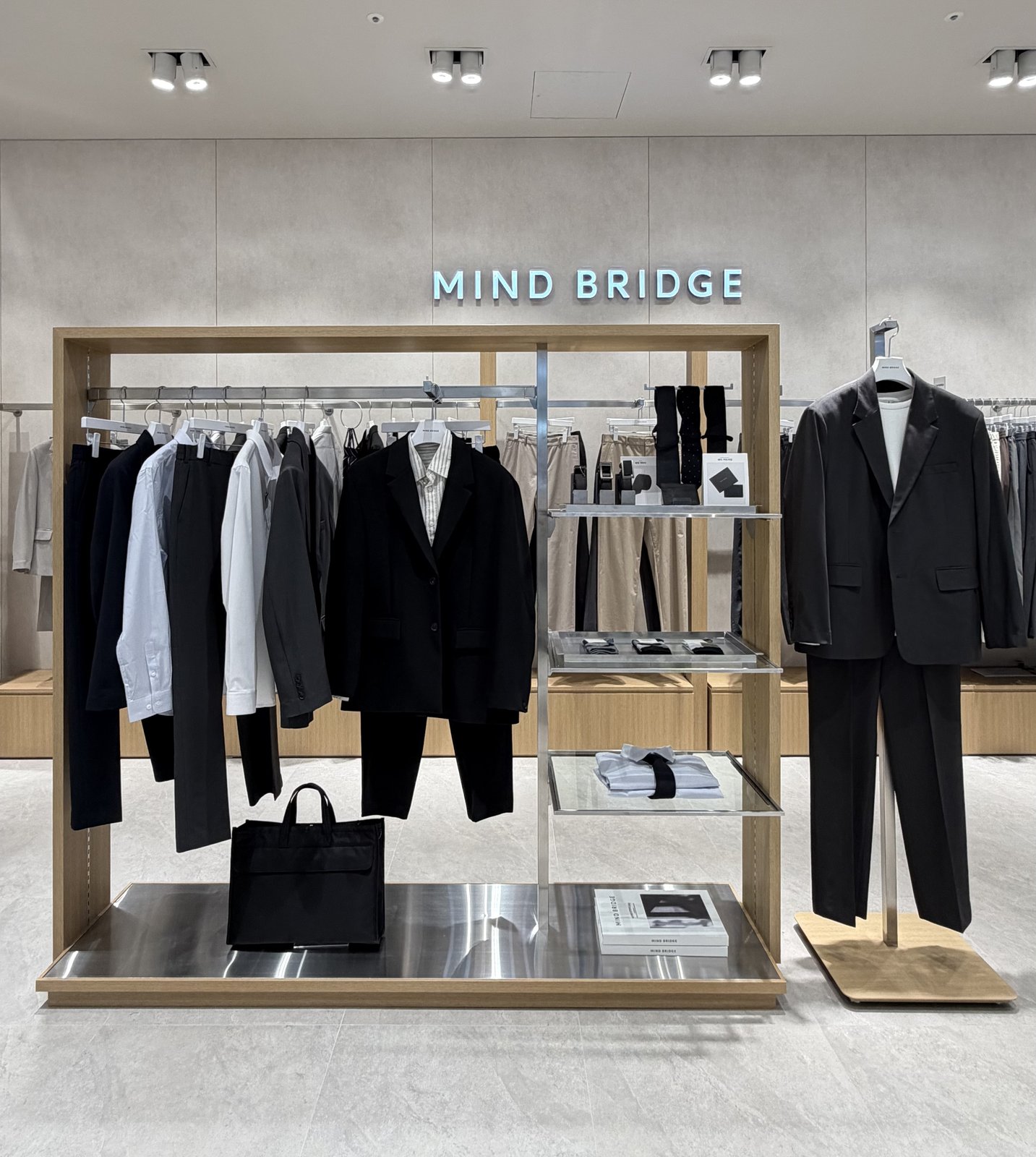 Suiting display with blazer, ties, and leather bags