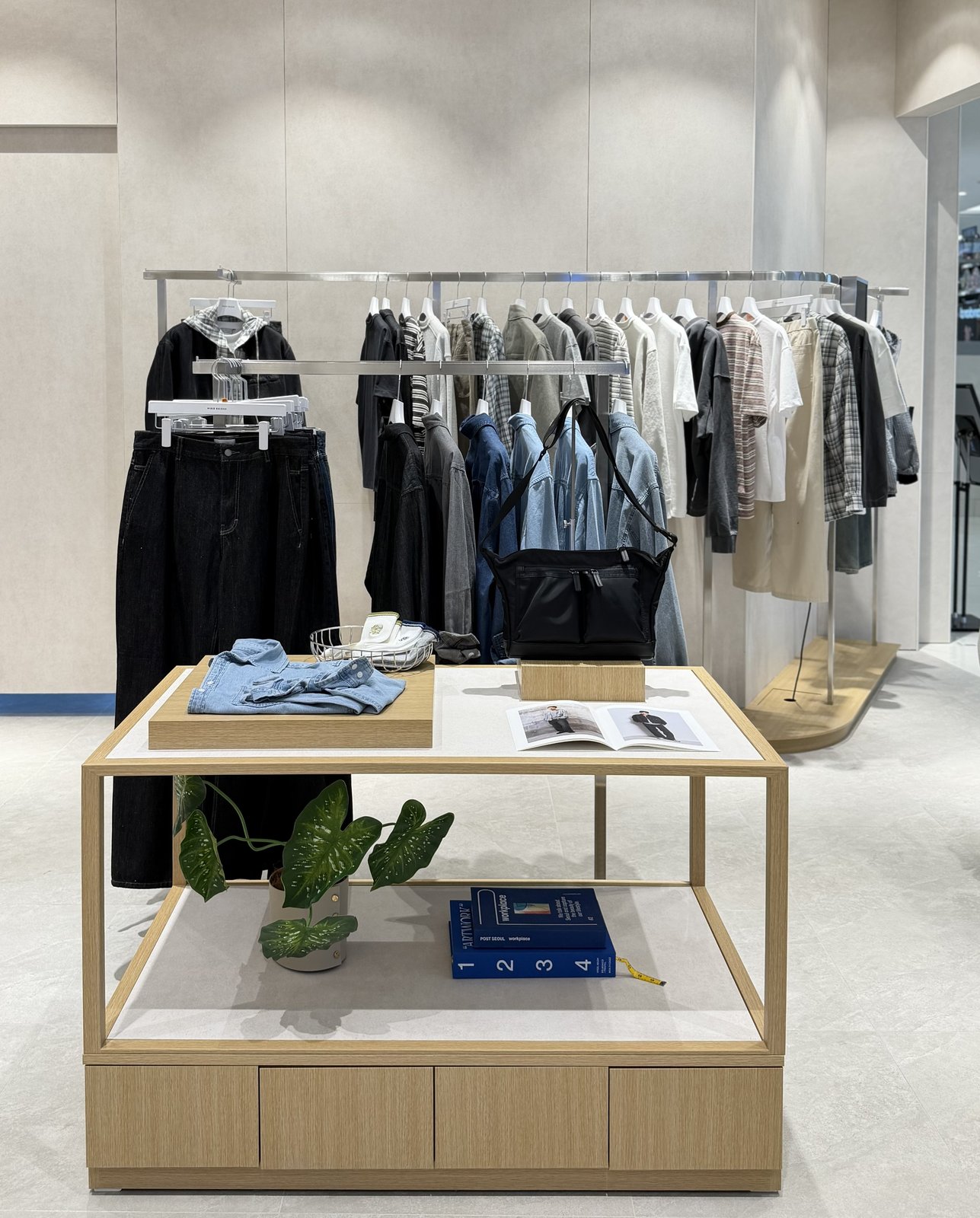 Denim rail and display table with books and folded shirts